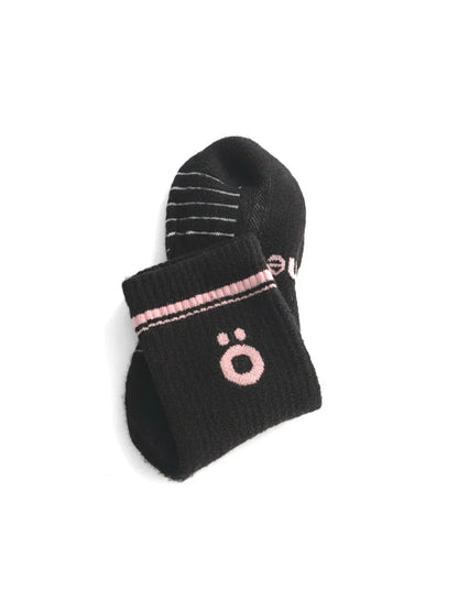 Detail of black höhen merino socks with logo and ribbed finish, soft and durable for active use