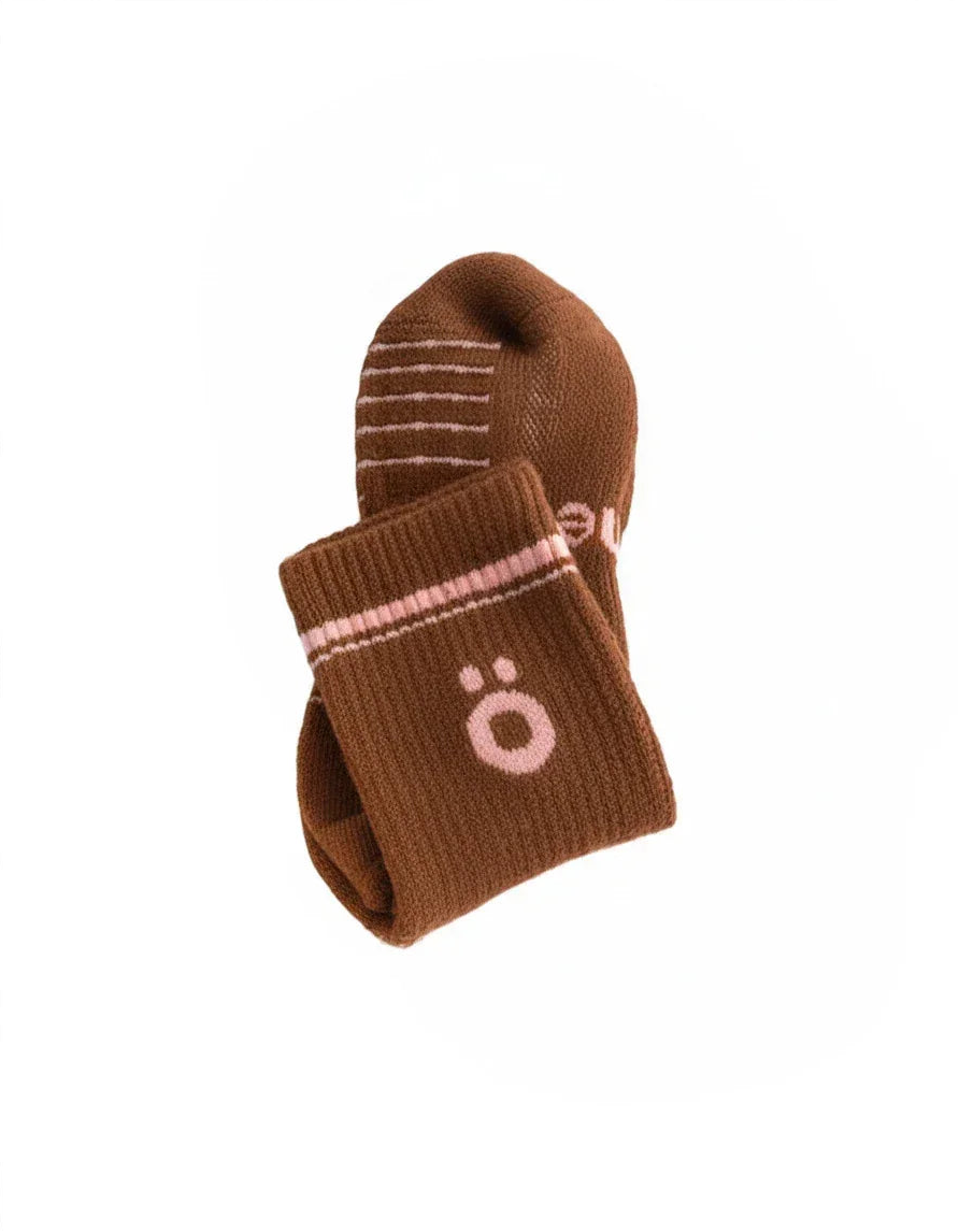 Detail of brown höhen merino socks with logo and ribbed finish, soft and durable for active use