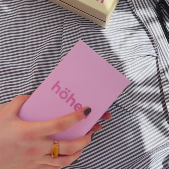 Unboxing video of the brown and pink höhen core merino wool socks, showing the premium pink box packaging, tissue paper wrap, and a close-up of the socks being worn to highlight their fit and athletic compression lines