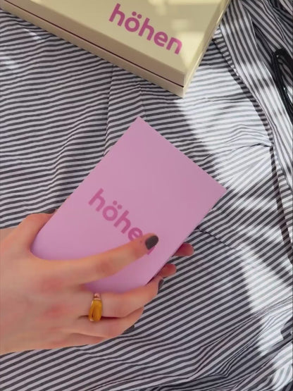 Unboxing video of the brown and pink höhen core merino wool socks, showing the premium pink box packaging, tissue paper wrap, and a close-up of the socks being worn to highlight their fit and athletic compression lines