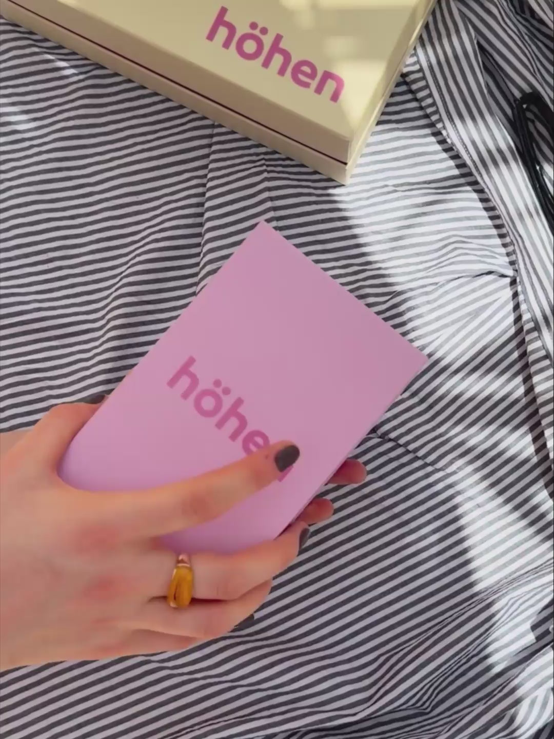 Unboxing video of the brown and pink höhen core merino wool socks, showing the premium pink box packaging, tissue paper wrap, and a close-up of the socks being worn to highlight their fit and athletic compression lines
